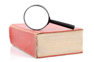 Image of red book with magnifying glass