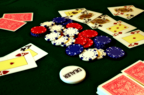 poker cards with casino chips and dealer chip